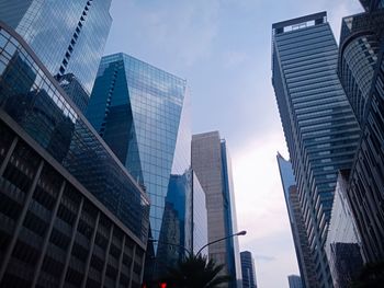 Low angle view of modern buildings in city against sky