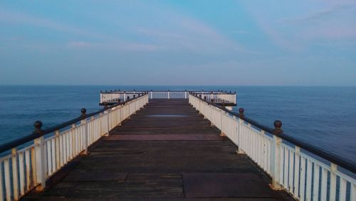 Pier over sea against sky