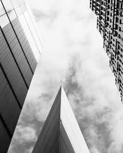 Low angle view of modern building against cloudy sky