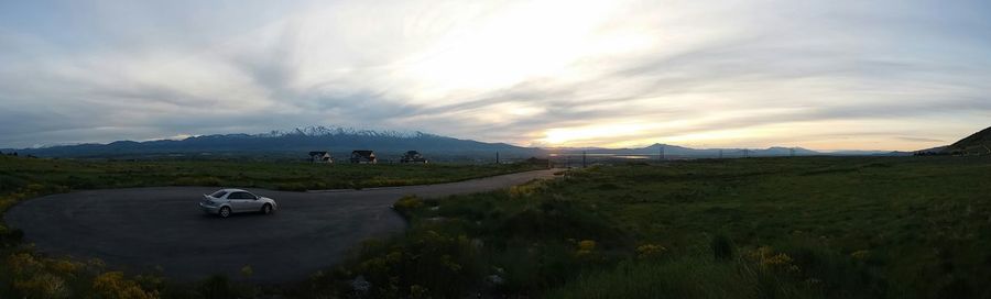 Scenic view of landscape against cloudy sky