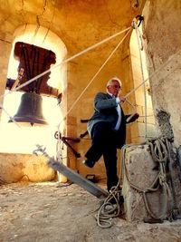 Full length portrait of man standing on rock