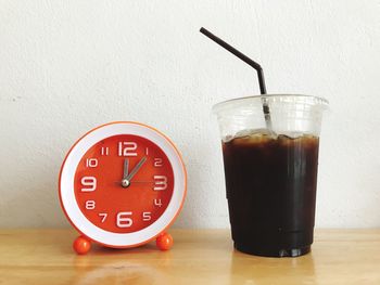 Close-up of drink served on table against wall