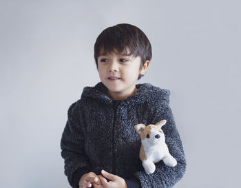 Portrait of cute boy against white background