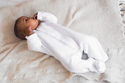 High angle view of baby sleeping on bed