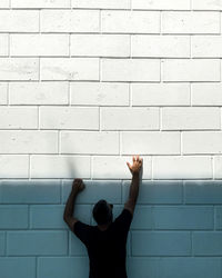 Full length of man standing against wall