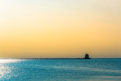 Scenic view of sea against clear sky during sunset