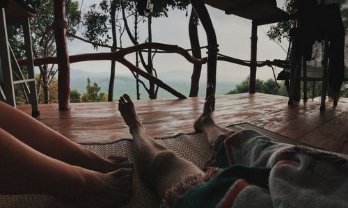 Low section of woman lying on tree house