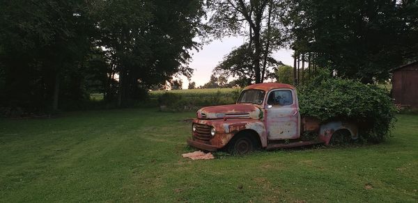 Abandoned car on field