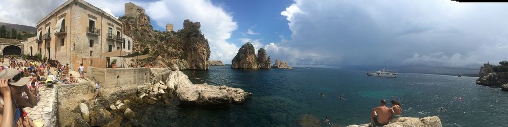 Panoramic view of sea and rocks against sky