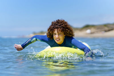 Young woman swimming in sea