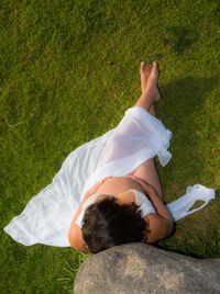 High angle view of woman relaxing on field