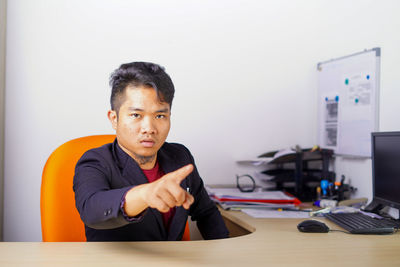 Portrait of young man sitting at table