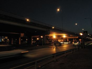 Illuminated railroad station platform at night