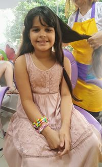 Portrait of a smiling girl sitting outdoors