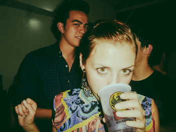 Portrait of young man drinking coffee