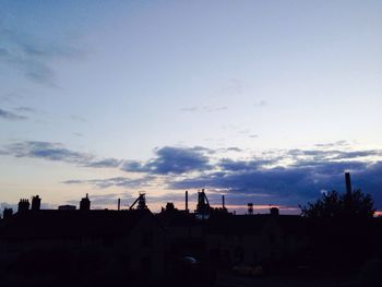 Buildings against sky at sunset