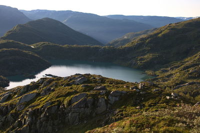 Scenic view of lake and mountains against sky