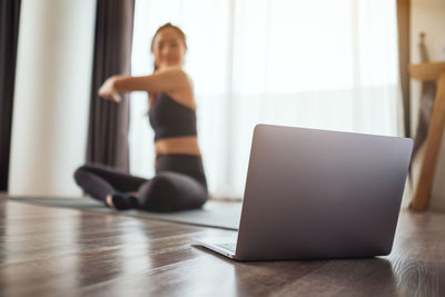 Young woman using laptop at home