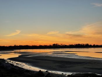 Scenic view of beach against sky during sunset