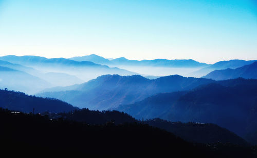 Scenic view of silhouette mountains against clear sky