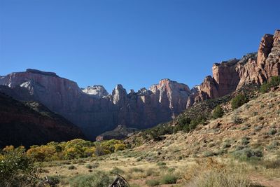 Panoramic view of rocky mountains against clear sky