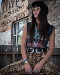 Beautiful woman standing against building