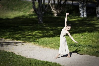 Full length of woman dancing at park