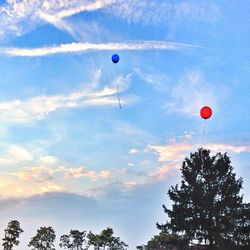 Low angle view of balloons flying in sky