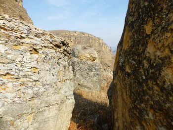 Low angle view of rock formations against sky