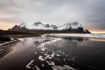 Scenic view of snowcapped mountains against sky during winter