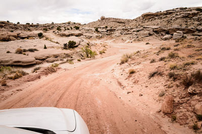 Scenic view of desert road against sky