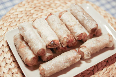 High angle view of spring rolls in plate on table