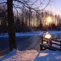 Snow covered landscape at sunset