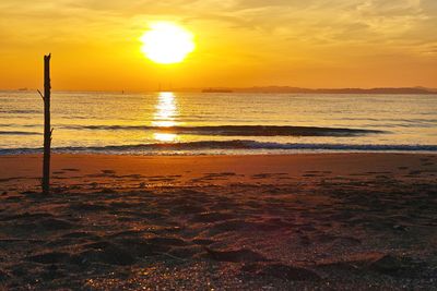 Scenic view of beach against sky during sunset