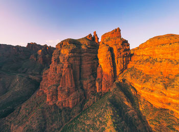 Rock formations on landscape against sky