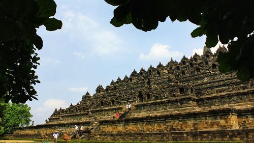 Low angle view of temple against cloudy sky