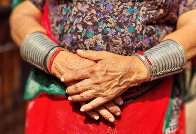 Midsection of couple holding hands