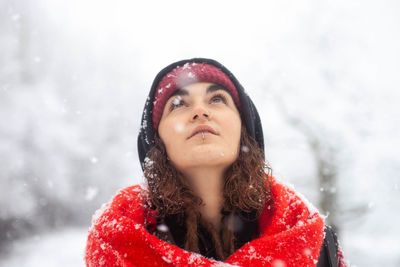 Portrait of young woman standing on snow