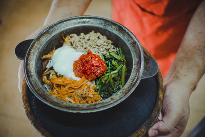 High angle view of person preparing food in plate