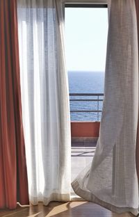 Scenic view of sea against clear sky seen through window