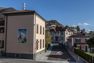 Houses by street in town against sky