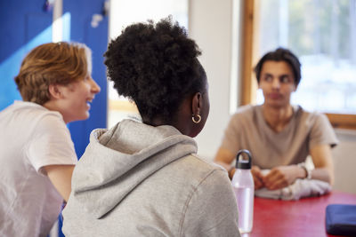 Teenagers talking in locker room