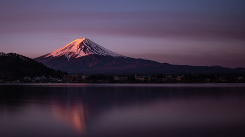 Scenic view of lake with mountain range in background