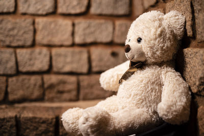 Close-up of stuffed toy against wall