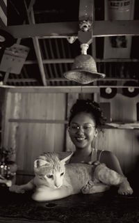 Portrait of smiling girl with cat