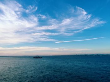 Scenic view of sea against cloudy sky