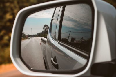 Close-up of side-view mirror of car