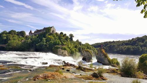 Scenic view of waterfall against sky