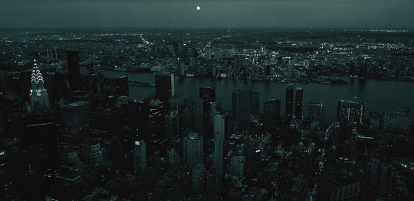 High angle view of city lit up at night