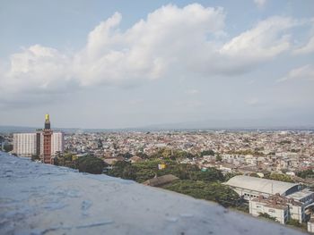 Aerial view of buildings in city against sky
